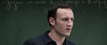Movie still from “The Class” (2008), directed by Laurent Cantet – A man standing in front of a chalkboard; Close Up shot, Over the shoulder angle
