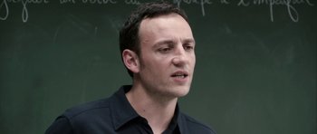 Movie still from “The Class” (2008), directed by Laurent Cantet – A man standing in front of a chalkboard; Close Up shot, Low angle