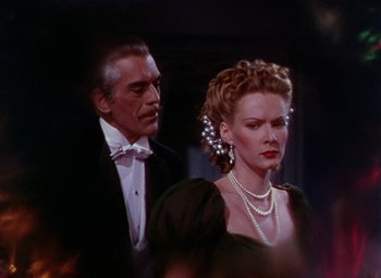 Movie still from “The Climax” (1944), directed by George Waggner – A man and a woman in formal wear standing next to each other; Close Up shot, Low angle