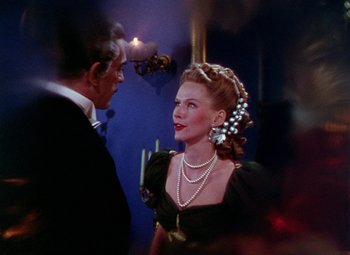 Movie still from “The Climax” (1944), directed by George Waggner – A man and a woman dressed in formal wear; Close Up shot, Over the shoulder angle