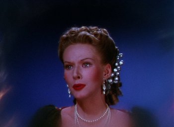 Movie still from “The Climax” (1944), directed by George Waggner – A woman wearing pearls and a necklace with pearls around her neck; Close Up shot, Low angle