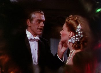 Movie still from “The Climax” (1944), directed by George Waggner – A man and a woman in formal wear talking to each other; Close Up shot, Over the shoulder angle