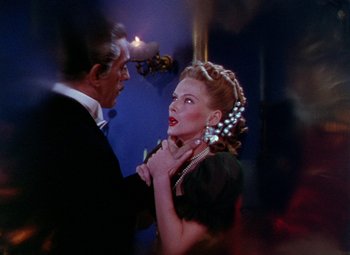 Movie still from “The Climax” (1944), directed by George Waggner – A man and a woman in formal wear are looking at each other; Close Up shot, Over the shoulder angle