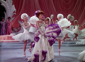 Movie still from “The Climax” (1944), directed by George Waggner – A group of women dressed up in costumes and dancing; Wide shot, Low angle