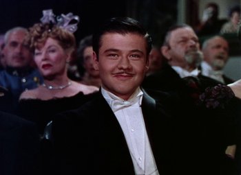 Movie still from “The Climax” (1944), directed by George Waggner – A man in a black suit and a white bow tie; Close Up shot, Low angle