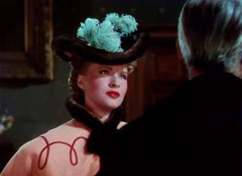 Movie still from “The Climax” (1944), directed by George Waggner – A woman in a hat and a fur coat; Close Up shot, Over the shoulder angle
