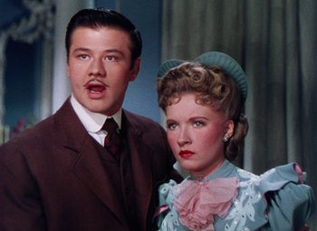 Movie still from “The Climax” (1944), directed by George Waggner – A man and a woman standing next to each other; Close Up shot, Low angle