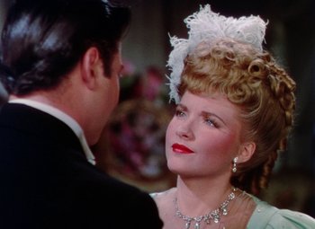 Movie still from “The Climax” (1944), directed by George Waggner – A man and a woman in formal wear looking at one another; Close Up shot, Over the shoulder angle