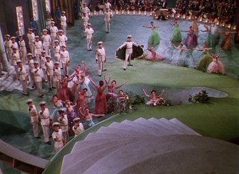 Movie still from “The Climax” (1944), directed by George Waggner – An aerial view of a crowd of people standing in a field; Extreme Wide shot, High angle