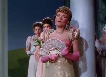 Movie still from “The Climax” (1944), directed by George Waggner – A group of women dressed up in fancy clothing; Medium shot, Low angle