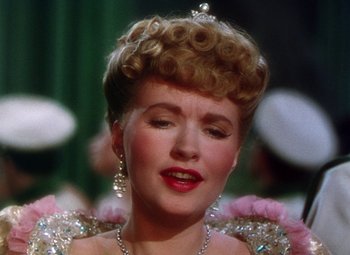 Movie still from “The Climax” (1944), directed by George Waggner – A person wearing a dress and a tiara; Close Up shot, Low angle