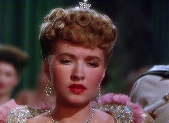 Movie still from “The Climax” (1944), directed by George Waggner – A person wearing a tiara and a necklace; Close Up shot, Over the shoulder angle