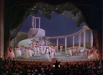Movie still from “The Climax” (1944), directed by George Waggner – A large audience is watching a scene in a theater; Extreme Wide shot, High angle