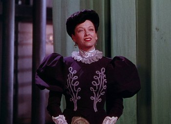 Movie still from “The Climax” (1944), directed by George Waggner – A woman wearing a black dress and a hat; Medium shot, Low angle