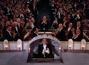 Movie still from “The Climax” (1944), directed by George Waggner – A crowd of people sitting in front of an audience; Wide shot, High angle
