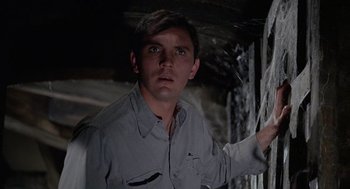 Movie still from “The Collector” (1965), directed by William Wyler – A man in a gray shirt is looking at the camera; Close Up shot, Low angle