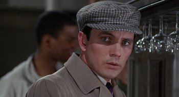 Movie still from “The Collector” (1965), directed by William Wyler – A person wearing a coat and a hat; Close Up shot, Over the shoulder angle