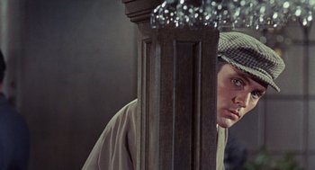 Movie still from “The Collector” (1965), directed by William Wyler – A man in a hat looking at himself in a mirror; Close Up shot, Over the shoulder angle