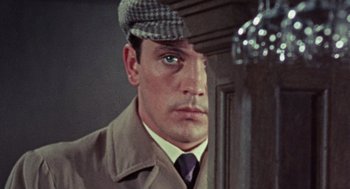 Movie still from “The Collector” (1965), directed by William Wyler – A person wearing a coat and a hat; Close Up shot, High angle