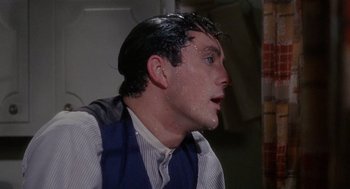 Movie still from “The Collector” (1965), directed by William Wyler – A man with wet hair and a blue vest; Close Up shot, Over the shoulder angle