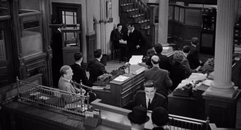 Movie still from “The Collector” (1965), directed by William Wyler – A black and white photo of people sitting in a room; Wide shot, High angle