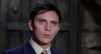Movie still from “The Collector” (1965), directed by William Wyler – A person wearing a suit and tie; Close Up shot, High angle