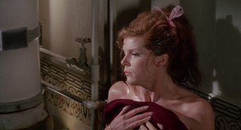 Movie still from “The Collector” (1965), directed by William Wyler – A woman with red hair wrapped in a red towel; Close Up shot, Over the shoulder angle