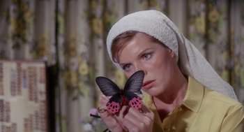 Movie still from “The Collector” (1965), directed by William Wyler – A woman holding a butterfly in her hands; Close Up shot, Low angle