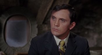 Movie still from “The Collector” (1965), directed by William Wyler – A person wearing a suit and tie; Close Up shot, High angle