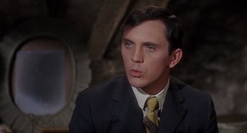 Movie still from “The Collector” (1965), directed by William Wyler – A person wearing a suit and tie; Close Up shot, High angle