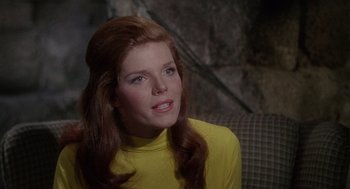 Movie still from “The Collector” (1965), directed by William Wyler – A woman with long red hair wearing a yellow shirt; Close Up shot, High angle