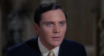 Movie still from “The Collector” (1965), directed by William Wyler – A person wearing a suit and tie; Close Up shot, High angle