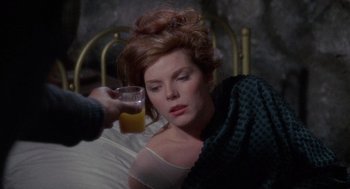 Movie still from “The Collector” (1965), directed by William Wyler – A woman drinking a glass of orange juice in bed; Close Up shot, High angle