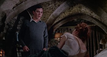 Movie still from “The Collector” (1965), directed by William Wyler – A man and a woman standing next to each other in a room; Medium shot, Over the shoulder angle