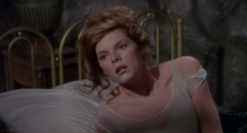 Movie still from “The Collector” (1965), directed by William Wyler – A woman in a white shirt is laying in a bed; Close Up shot, High angle