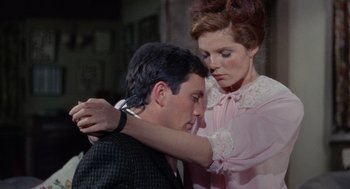 Movie still from “The Collector” (1965), directed by William Wyler – A man and a woman are holding each other in a room; Close Up shot, Low angle