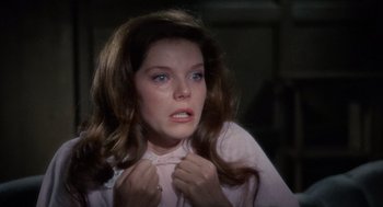 Movie still from “The Collector” (1965), directed by William Wyler – A woman with long brown hair wearing a pink shirt; Close Up shot, High angle
