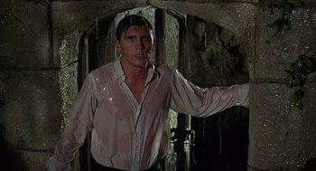 Movie still from “The Collector” (1965), directed by William Wyler – A man standing in front of an open door; Medium shot, Low angle
