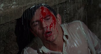 Movie still from “The Collector” (1965), directed by William Wyler – A man with blood all over his face and head; Close Up shot, High angle