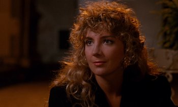 Movie still from “The Comfort of Strangers” (1990), directed by Paul Schrader – A person with long hair; Close Up shot, Over the shoulder angle