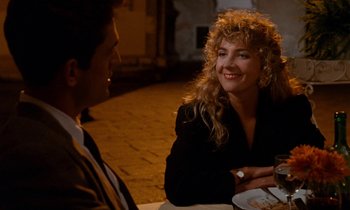 Movie still from “The Comfort of Strangers” (1990), directed by Paul Schrader – A man and a woman are sitting at a table together; Medium shot, Over the shoulder angle