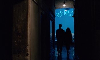 Movie still from “The Comfort of Strangers” (1990), directed by Paul Schrader – Two people are walking in an alleyway at night; Wide shot, Low angle