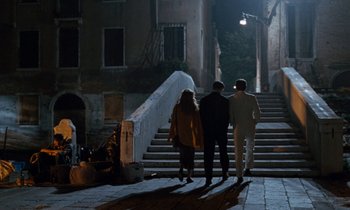 Movie still from “The Comfort of Strangers” (1990), directed by Paul Schrader – A group of people walking down a set of stairs; Wide shot, High angle