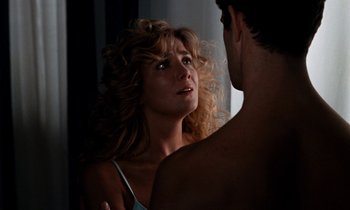 Movie still from “The Comfort of Strangers” (1990), directed by Paul Schrader – A man and a woman looking at one another in a mirror; Close Up shot, Over the shoulder angle