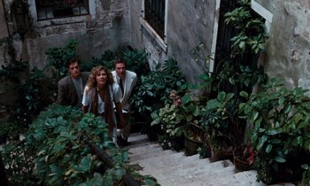Movie still from “The Comfort of Strangers” (1990), directed by Paul Schrader – A group of people walking down a set of stairs; Wide shot, High angle