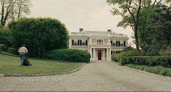 A large white house sitting on top of a gravel road