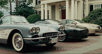 Movie still from “The Company Men” (2010), directed by John Wells – A couple of cars parked on the side of a road; Wide shot, High angle