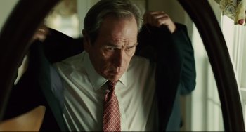 Movie still from “The Company Men” (2010), directed by John Wells – An older man wearing a suit and tie; Close Up shot, Low angle