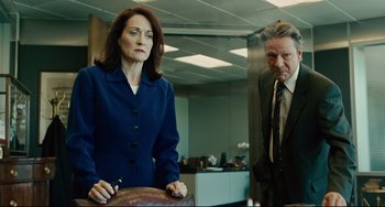 Movie still from “The Company Men” (2010), directed by John Wells – A man and a woman standing next to each other in an office; Medium shot, Low angle