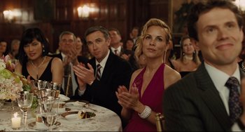 Movie still from “The Company Men” (2010), directed by John Wells – A man and a woman clapping at an event; Medium shot, Over the shoulder angle